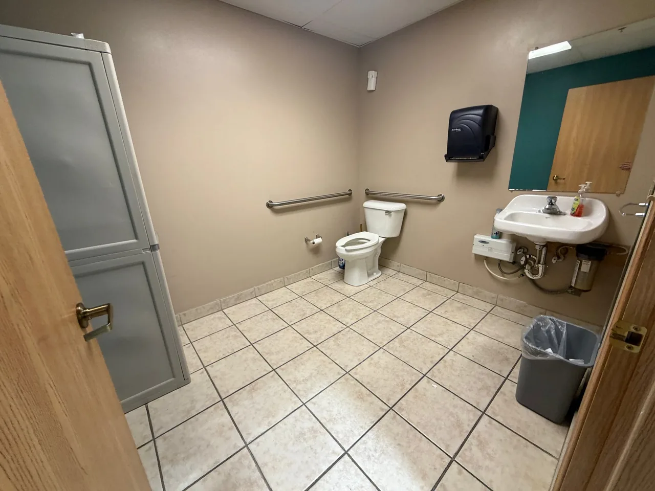 Recent Star Pro commercial clean: neutral-tone restroom with tile floor, sink, and fixtures finished