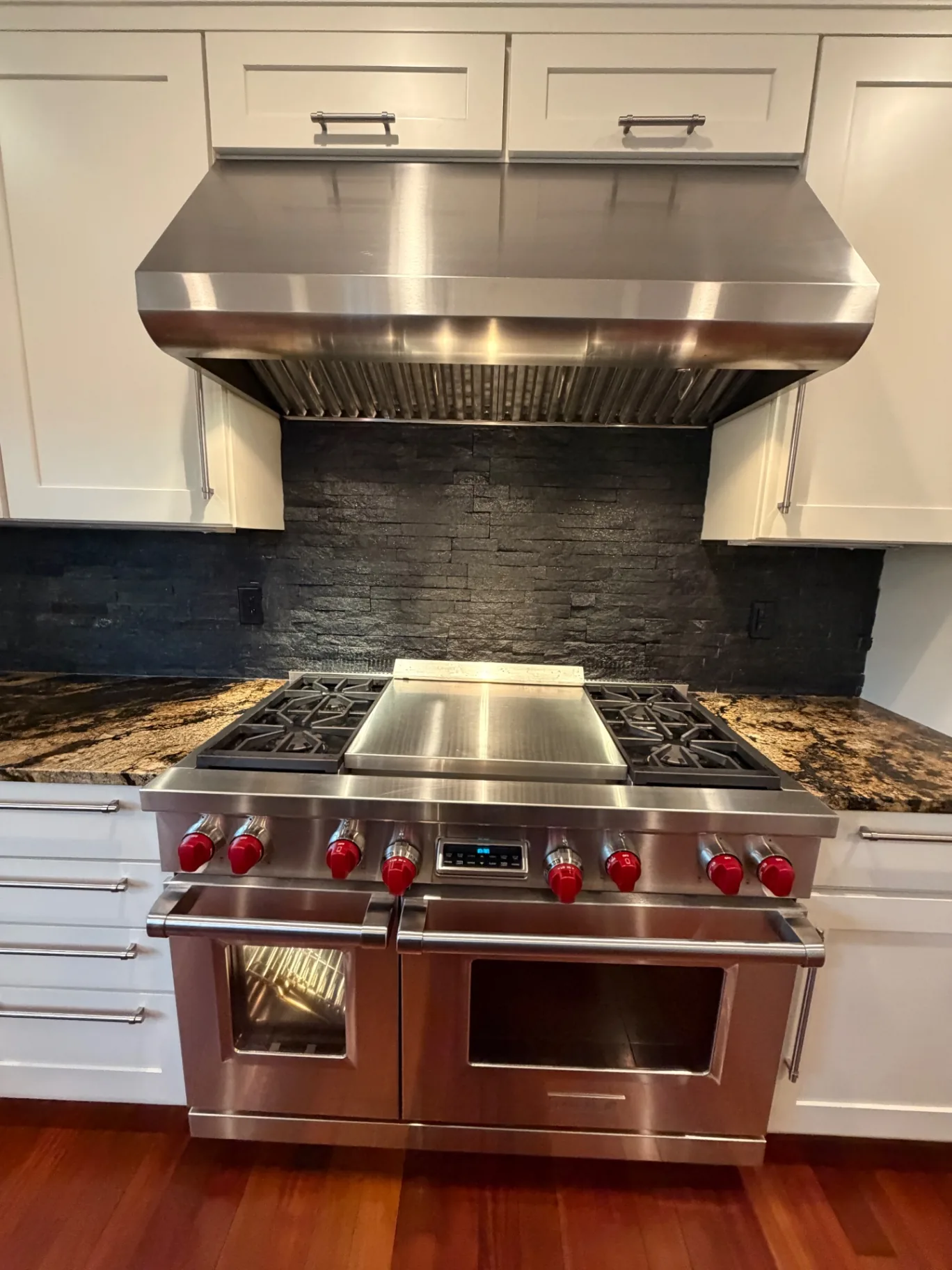 Professional range and stainless hood polished during a move-out clean