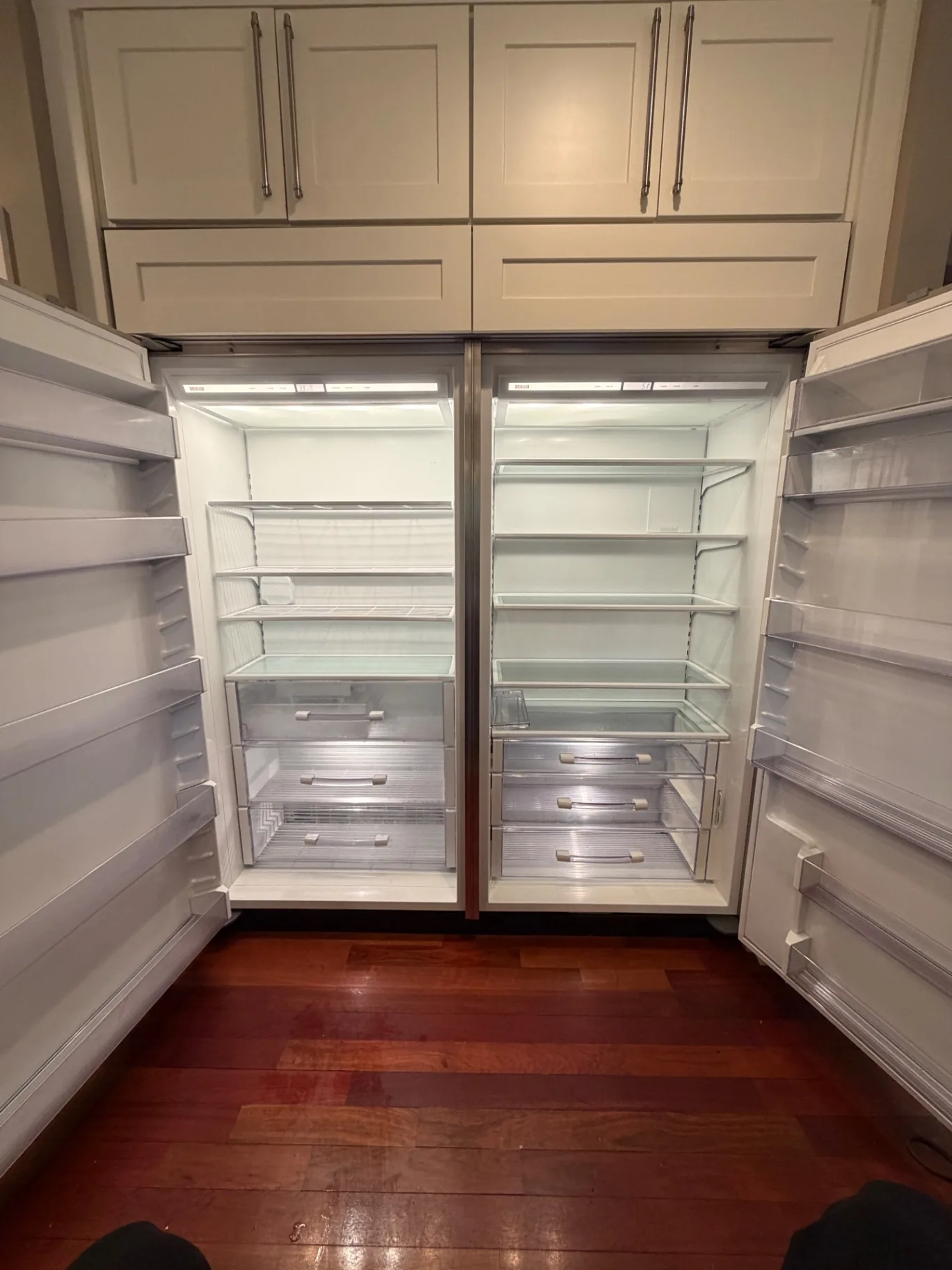 Built-in refrigerator interior, emptied and cleaned shelf by shelf for move-out